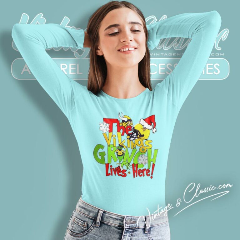 The Minnesota Vikings Grinch Lives Here Merry Christmas Long Sleeve Tee The Minnesota Vikings Grinch Lives Here Merry Christmas Long Sleeve Tee